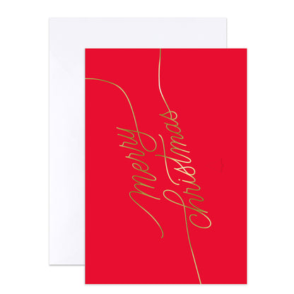 A red greeting card with elegant gold cursive script reading 'Merry Christmas' and a white envelope behind it, shown on a clean white background.