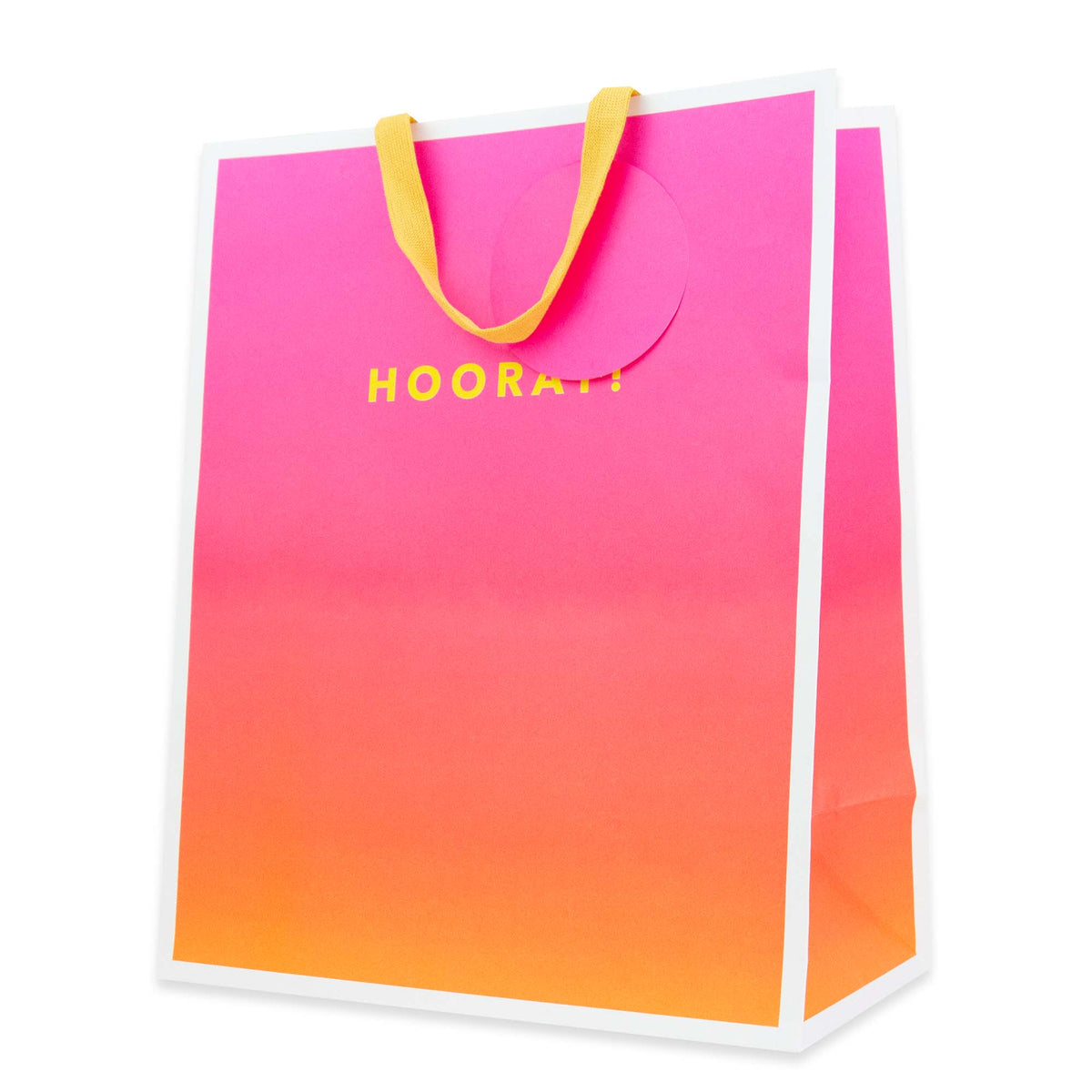 A bright pink and orange gradient paper shopping bag with yellow handles and the word 'HOORAI!' printed in yellow on the front, shown on a white background.