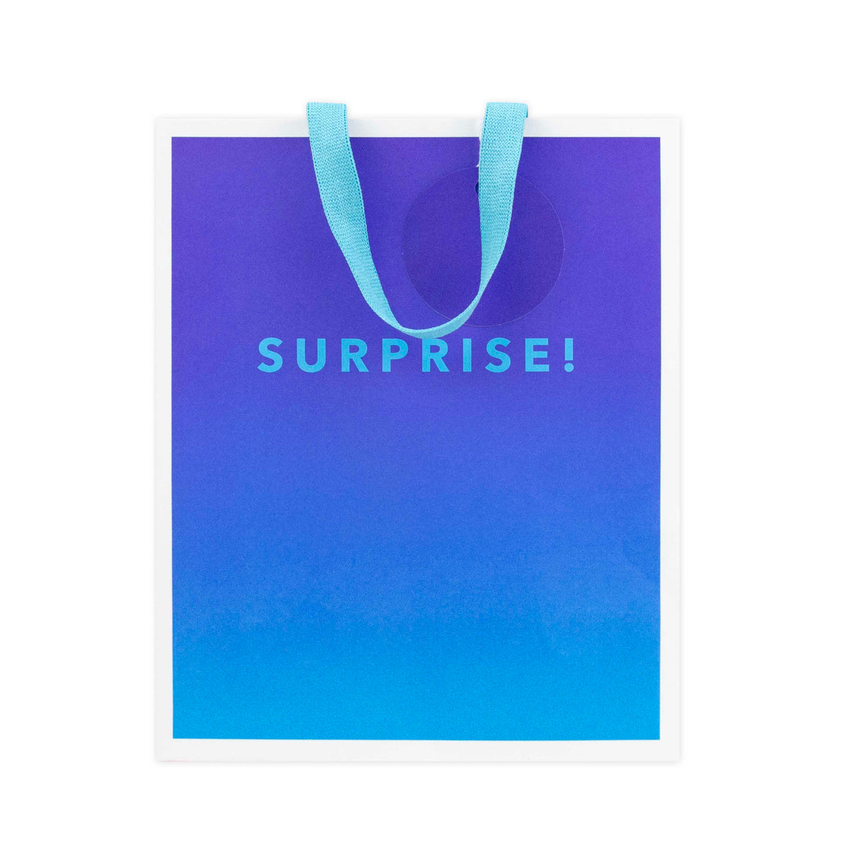 A square shopping bag with a blue-to-purple gradient front panel, light blue handles, and the word 'SURPRISE!' printed in light blue across the center, shown on a plain white background.