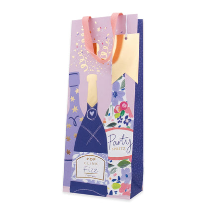 A decorative paper gift bag featuring a purple and blue champagne bottle illustration, floral patterns, gold foil stars, and the text 'Party Visit' and 'Pop Clink Fizz'.