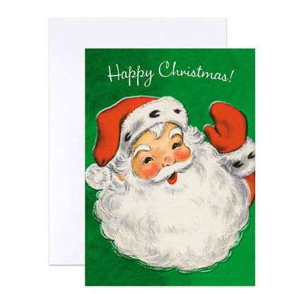 A Christmas greeting card with a white envelope behind it. The card features a vintage-style illustration of Santa Claus with a white beard, red hat, and red glove against a green background, with the words 'Happy Christmas!' in white script at the top.