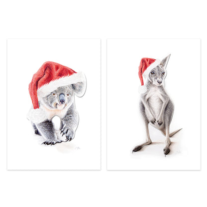 Two vertical art prints on a white background, each showing a small animal wearing a Santa hat: a koala on the left and a kangaroo on the right. The prints are shown as a pair with thin white borders.