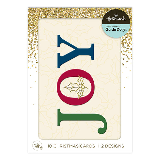 Hallmark Christmas cards for guide dogs, featuring a package of 10 Christmas cards with two designs. The front card displays the word 'JOY' in large letters: 'J' in navy blue, 'O' in red with a gold holly leaf design, and 'Y' in green.