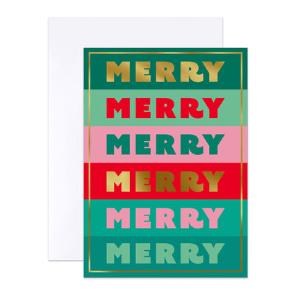 A festive greeting card with the word 'MERRY' repeated in alternating colors and metallic gold foil, shown in front of a plain white envelope on a white background.