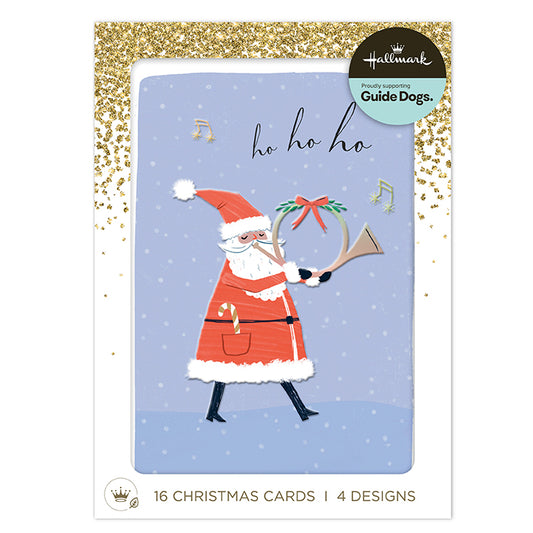 Hallmark 'Holiday with Your Guide Dogs' card set featuring a festive illustration of Santa Claus playing a trumpet on a light blue card with gold glitter accents.