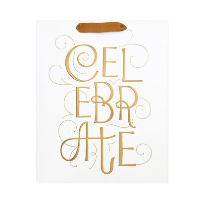 White paper gift bag with metallic gold foil lettering spelling 'CELEBRATE' and a small brown paper handle, shown on a plain white background.