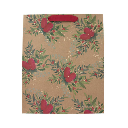 A kraft paper gift bag with a repeating pattern of green leaves, red berries, and red hearts, featuring a solid red handle on a white background.