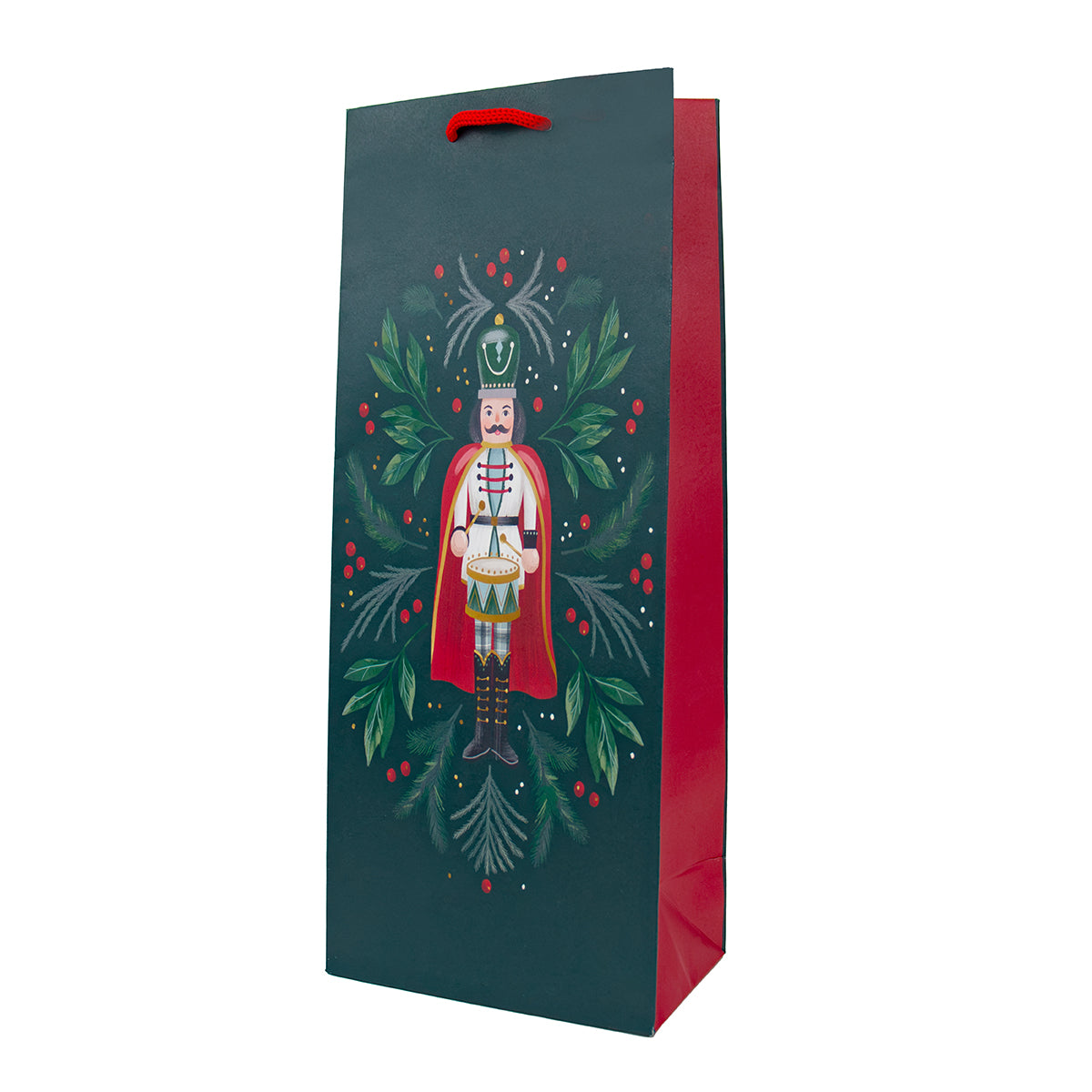 A dark teal Christmas-themed gift bag with a red handle and red inner side, featuring a printed illustration of a nutcracker surrounded by green holly leaves and red berries, shown on a plain white background.