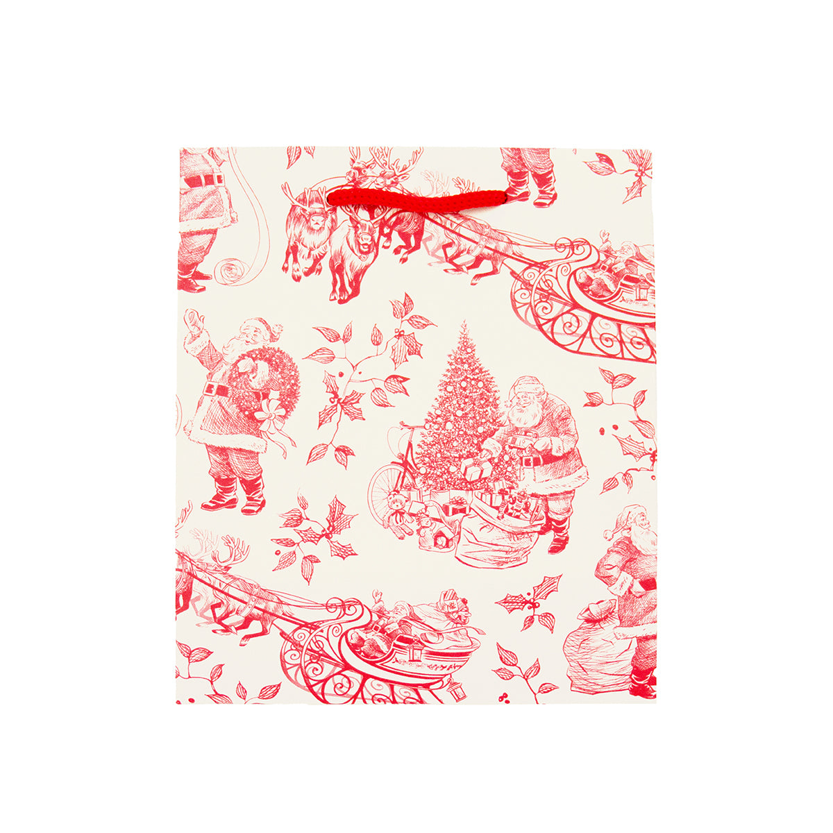 A square gift bag with a red Christmas toile de Jouy pattern on an off-white background, featuring Santa Claus, sleighs, and a Christmas tree, with a red paper handle.