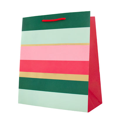 A striped paper gift bag with a red handle, featuring horizontal bands of dark green, light mint, pink, coral red, and beige on a white background.