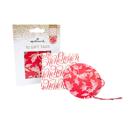 A set of 10 Hallmark Christmas gift tags, including one round tag and nine rectangular tags, all featuring a red and white holly and 'Ho Ho Ho' pattern. The set is shown both inside its white and gold retail packaging and as individual items on a clean white background.