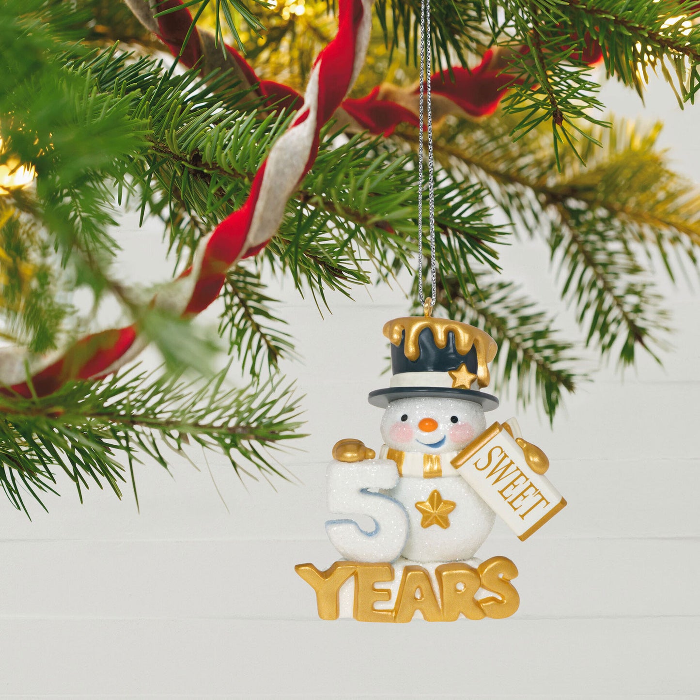 50 Sweet Years, Special Edition — Hallmark Keepsake Christmas Ornament featuring a glittery snowman with gold accents and candy bar, hanging on a tree