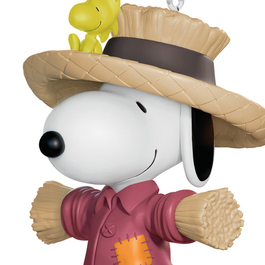 The Peanuts Gang Scarecrow Snoopy — 2026 Hallmark Keepsake 1.25" Mini Halloween Ornament, featuring Snoopy in a scarecrow costume with straw arms and Woodstock on his hat.