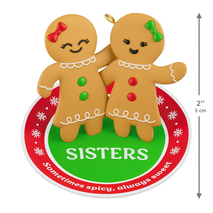 Sweet and Spicy Sisters — 2026 Hallmark Keepsake Christmas Ornament featuring gingerbread girls with bows on a festive rug, 5 cm.