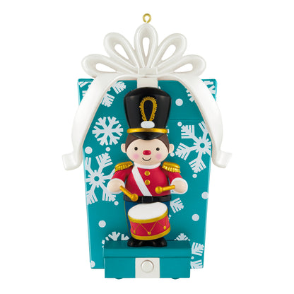 Toy soldier musical with motion — 2026 Hallmark Keepsake Christmas ornament featuring a drummer in front of a blue gift box with snowflakes.
