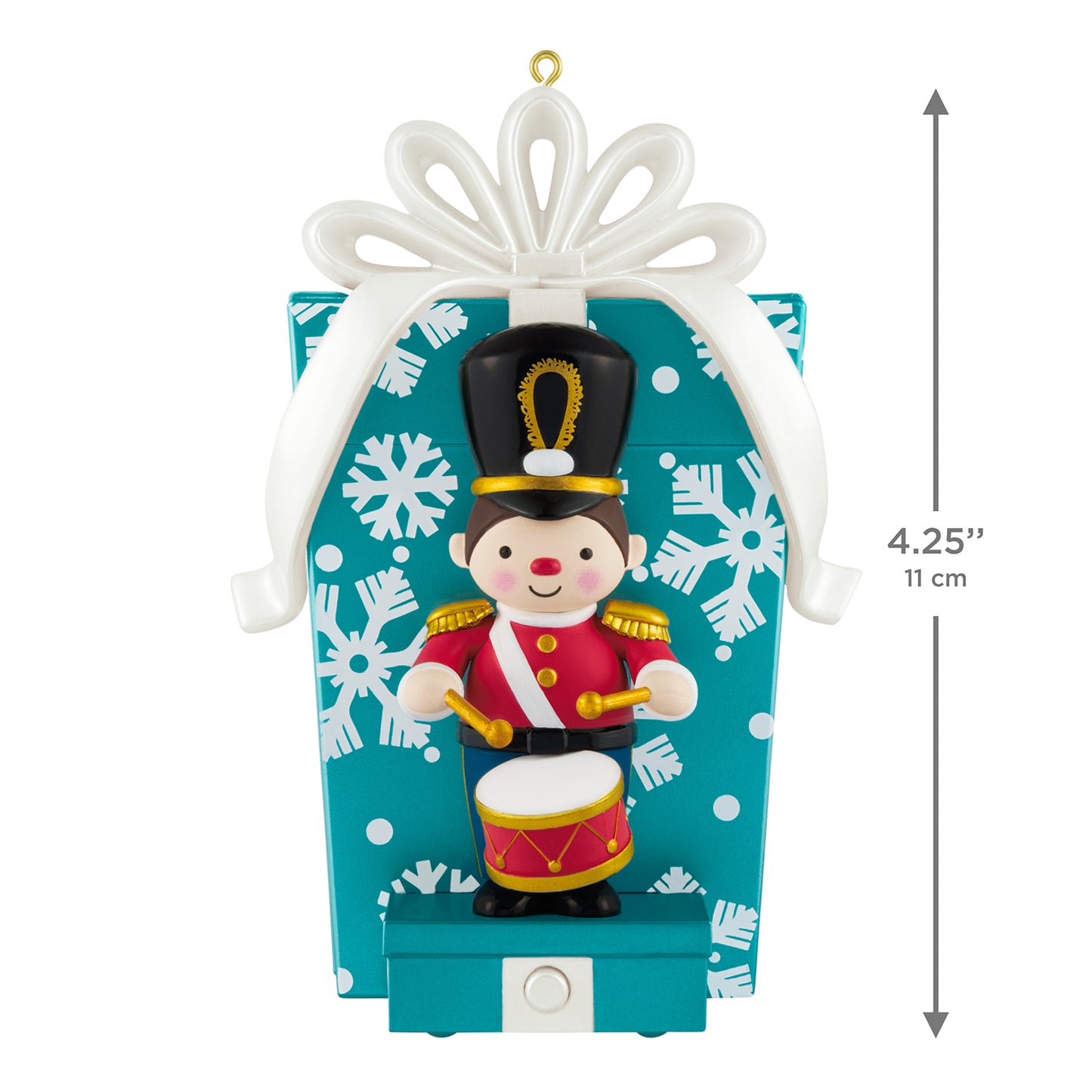 Toy Soldier Musical With Motion — 2026 Hallmark Keepsake Christmas Ornament sitting in front of a blue gift box with snowflakes.