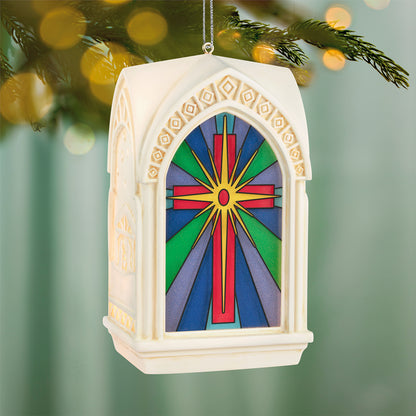 The Light of the World — 2026 Hallmark Keepsake Christmas Ornament featuring vibrant stained-glass design and ornate architecture, hanging on a tree.