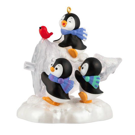 The Perfect Tree — 2026 Hallmark Keepsake Christmas Ornament featuring playful penguins with scarves carrying a snowy treasure, close up view.