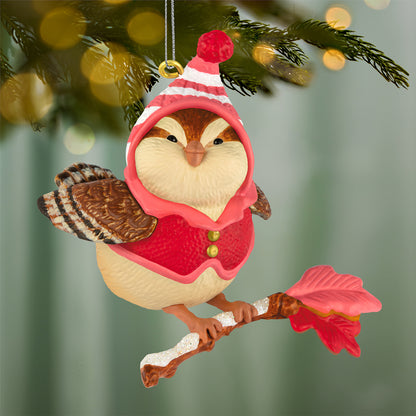 Cozy Critters Mystery — 2026 Hallmark Keepsake Christmas Ornament featuring a cute bird in a pink outfit, hanging on a branch with festive colours.