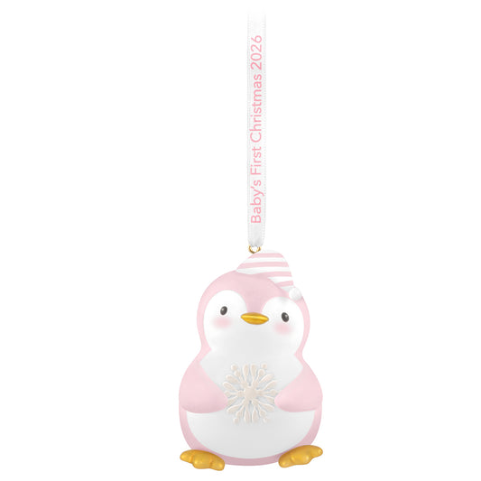 Baby girl's first Christmas penguin 2026 ornament, pink and white, featuring a snowflake and striped cap, hung with a ribbon.