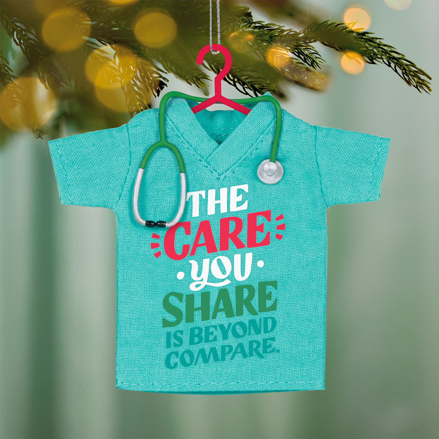 The Care You Share, Fabric — 2026 Hallmark Keepsake Christmas Ornament in teal fabric, featuring a stethoscope and gratitude message, close up view.