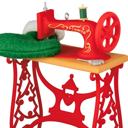Sew Nostalgic — 2026 Hallmark Keepsake Christmas Ornament featuring a red vintage sewing machine on a decorated table, close up detail.