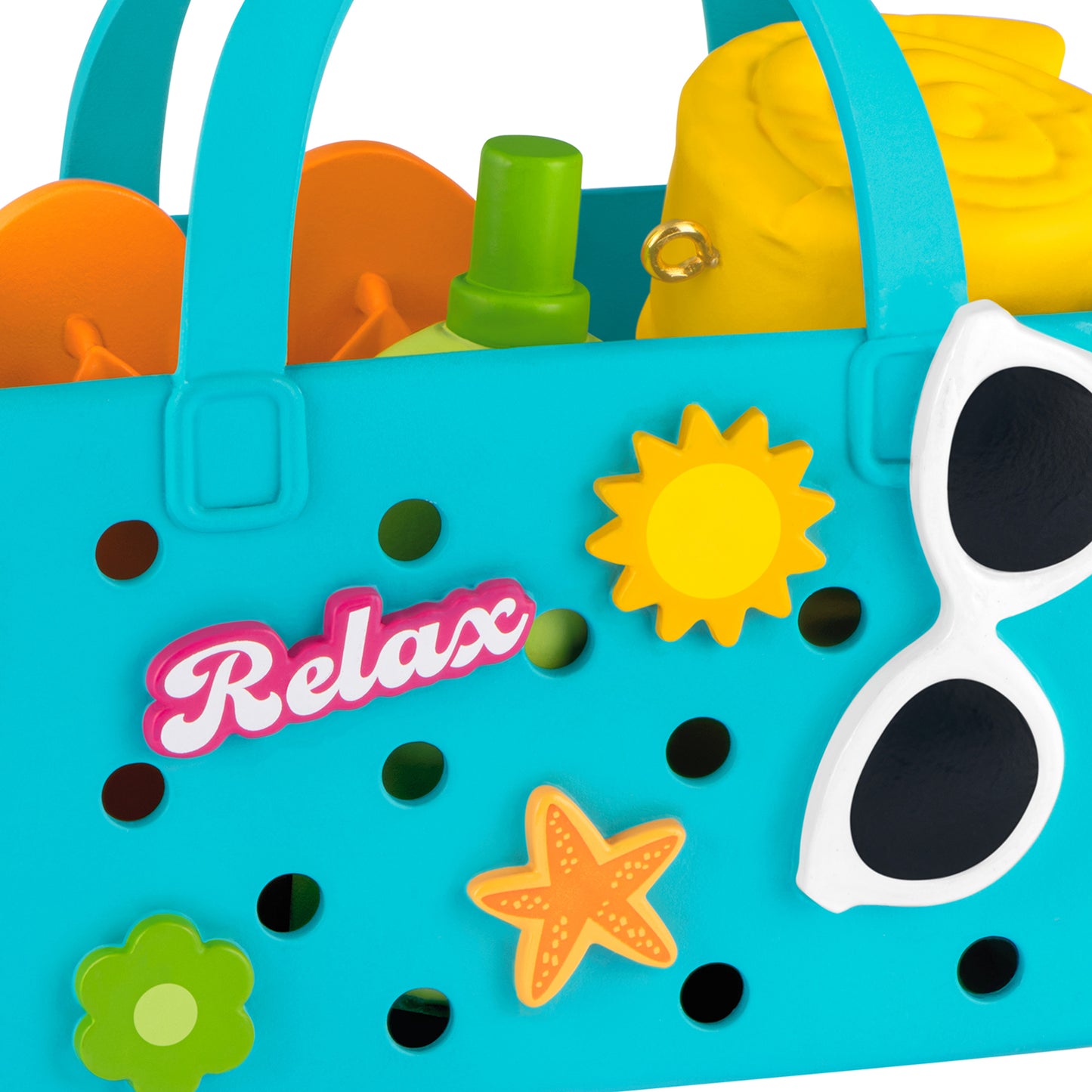 Relaxing at the Beach — 2026 Hallmark Keepsake Christmas Ornament, blue beach bag close up with flip-flops, towel, and sunscreen.