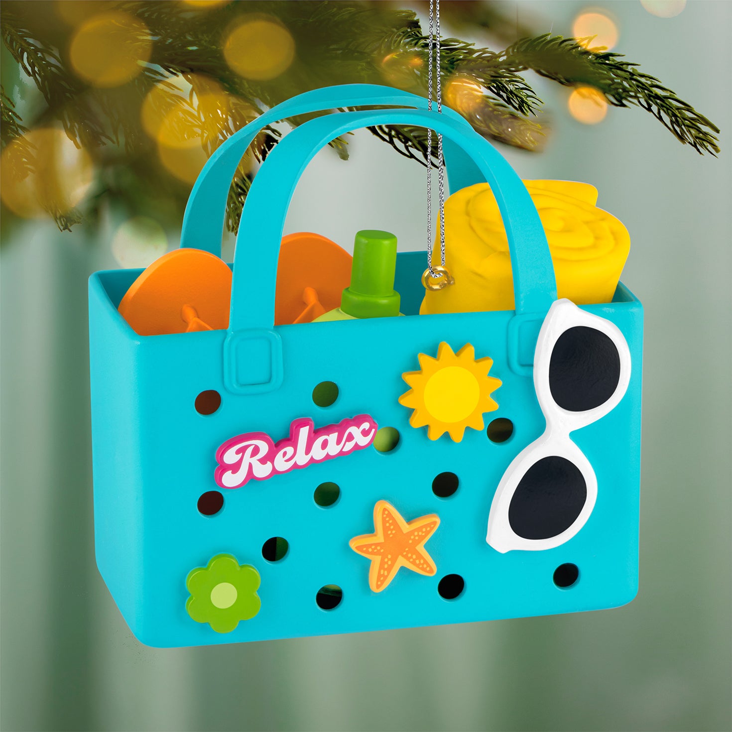 Relaxing at the Beach — 2026 Hallmark Keepsake Christmas Ornament, blue beach bag design with flip-flops and sunscreen, close up