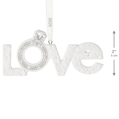 Our Engagement 2026, Porcelain — 2026 Hallmark Keepsake Christmas Ornament, white with floral details and diamond ring design, flat lay.