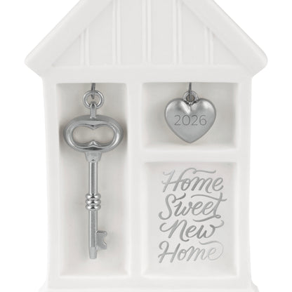Home Sweet New Home 2026, porcelain and metal ornament featuring a silver key and heart charm, detailed close-up view.