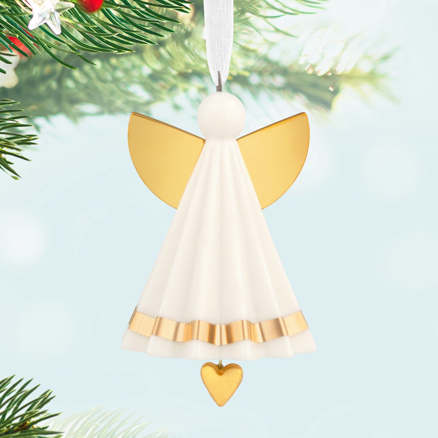 Petite Angel, Porcelain — 2026 Hallmark Keepsake 1.25" Mini Christmas Ornament featuring gold accents and a dangling heart charm on a tree.