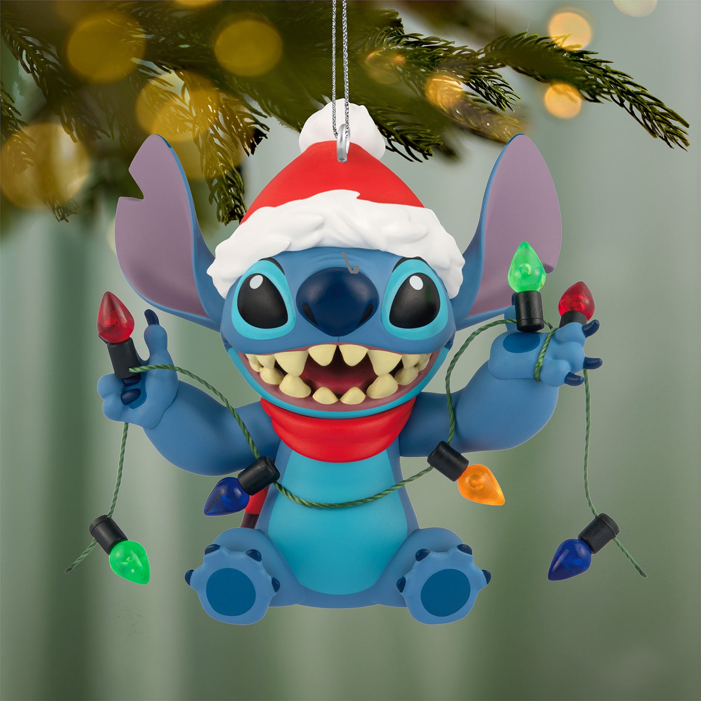 Disney Lilo & Stitch Shines Bright — 2026 Hallmark Keepsake Christmas Ornament featuring Stitch in a Santa hat with Christmas lights. Close up.