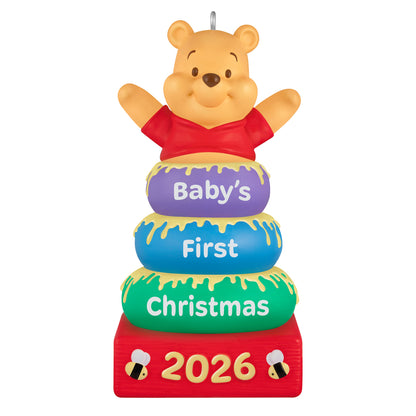 Disney Winnie the Pooh Baby's First Christmas 2026 — 2026 Hallmark Keepsake Christmas Ornament featuring Pooh atop colourful stacking rings with honey details