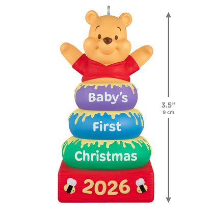 Disney Winnie the Pooh Baby's First Christmas 2026 — 2026 Hallmark Keepsake Christmas Ornament featuring Pooh atop colourful stacking rings with honey details, 9 cm tall.