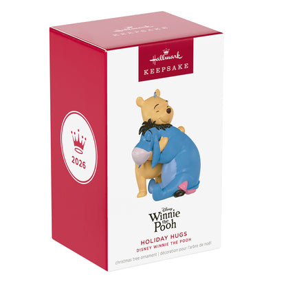 Disney Winnie the Pooh Holiday Hugs — 2026 Hallmark Keepsake Christmas Ornament in festive packaging, featuring Pooh and Eeyore embraced.