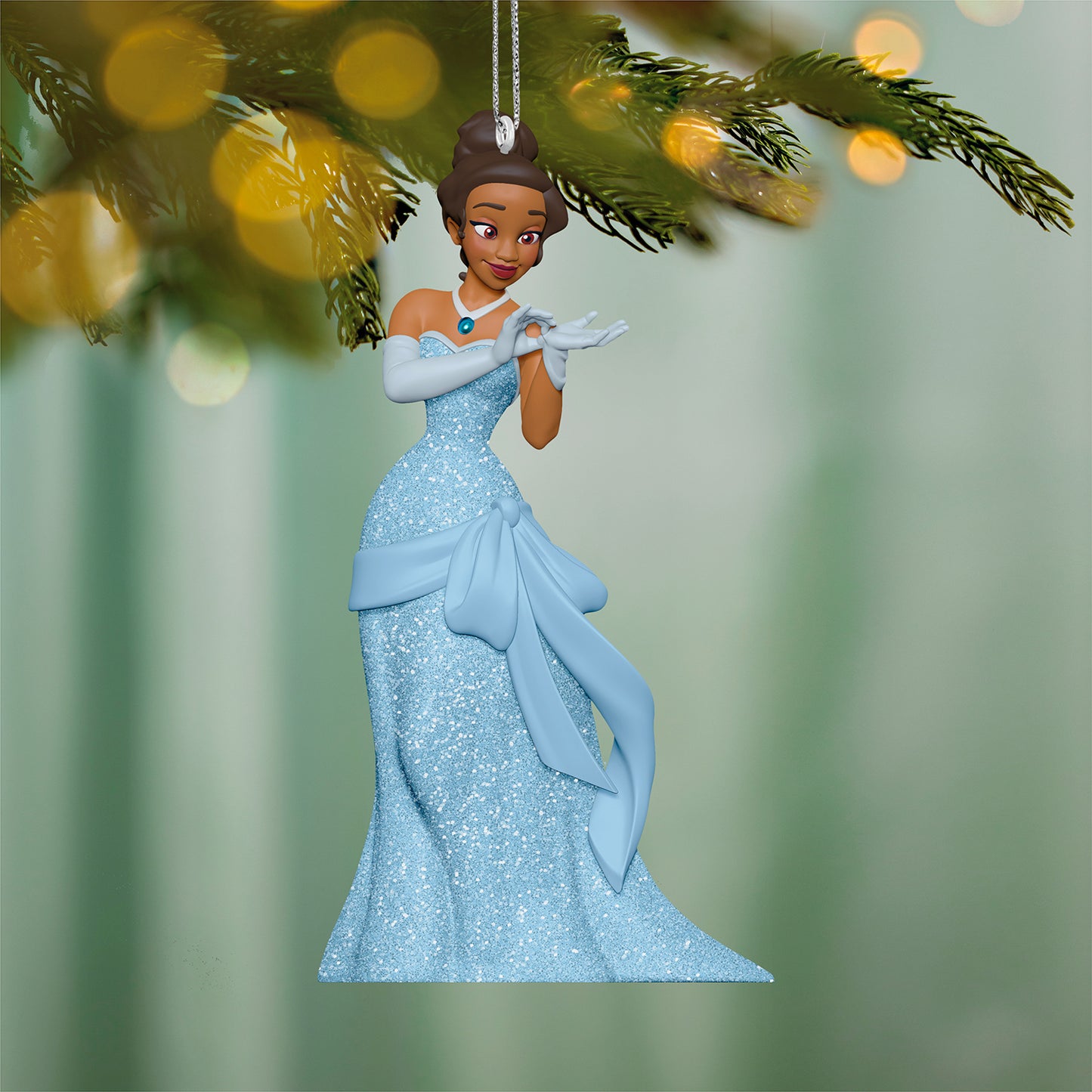 Disney The Princess and the Frog A Beauty in Blue — 2026 Hallmark Keepsake Christmas Ornament in sparkling blue gown, hanging from a tree.