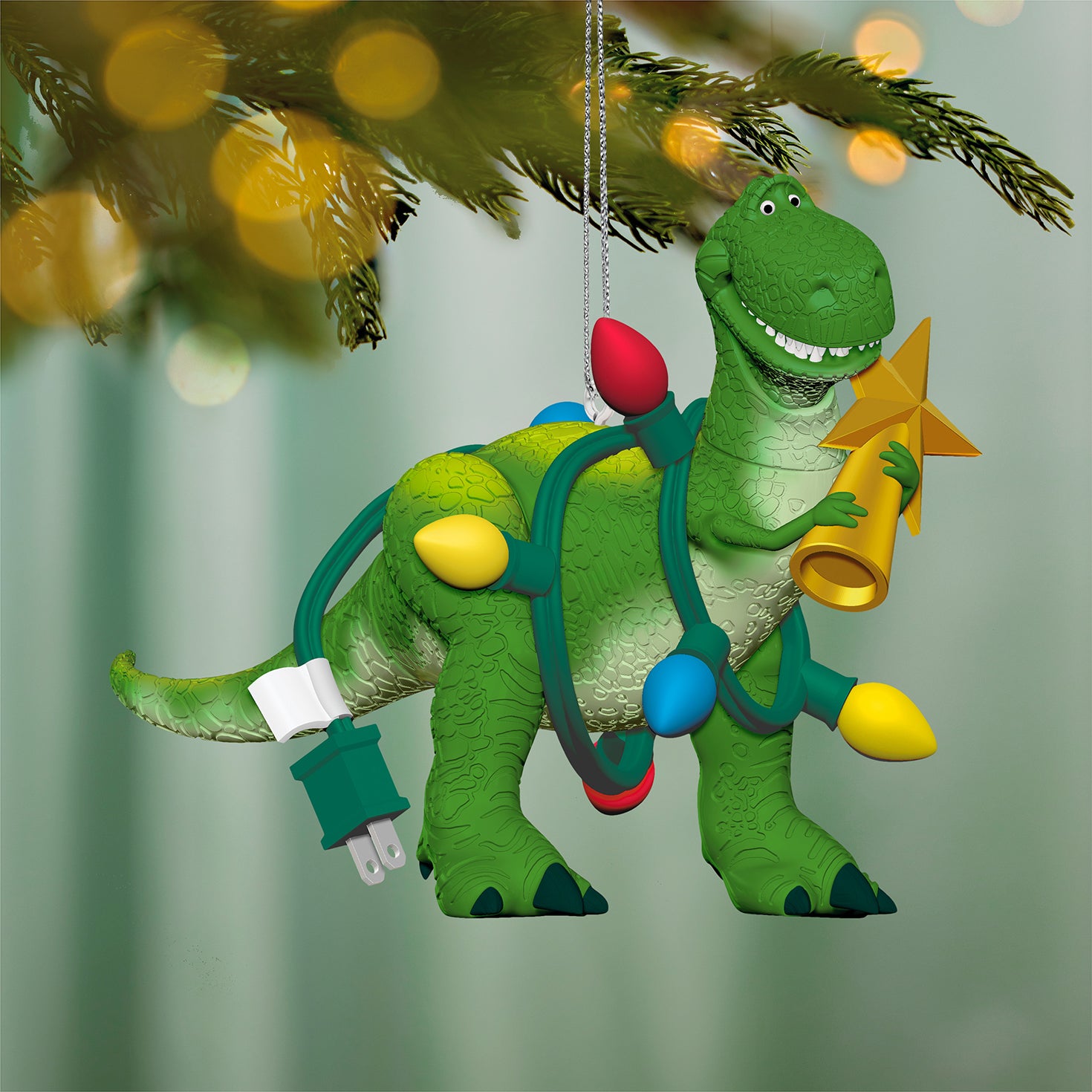 Disney/Pixar Toy Story Wrapped-Up Rex — 2026 Hallmark Keepsake Christmas Ornament, colourful lights and star, hanging from a Christmas tree