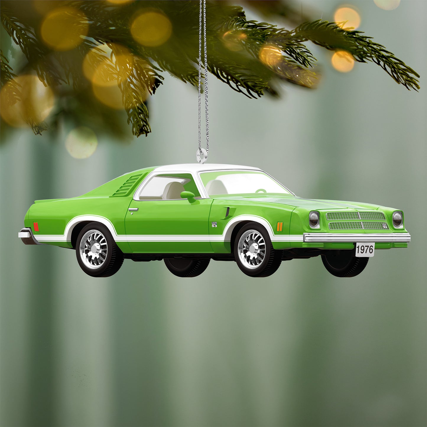 1976 Chevrolet Chevelle Laguna S-3 50th Anniversary 2026, metal ornament in vibrant green with detailed wheels, hanging on a pine tree branch.