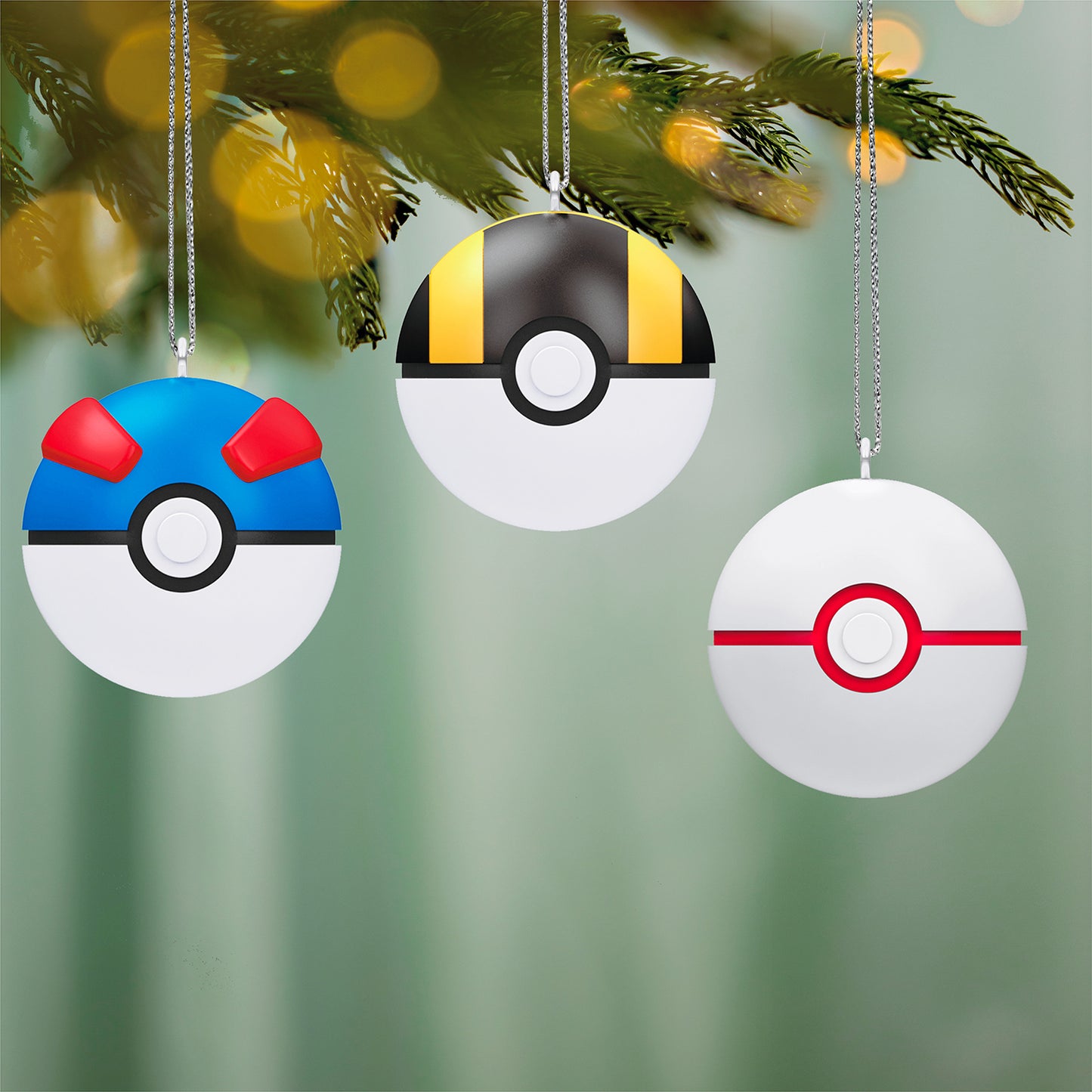 Pokémon Poké Ball, Set of 6 — 2026 Hallmark Keepsake Christmas Ornaments featuring three colourful Poké Balls hanging from a pine branch.