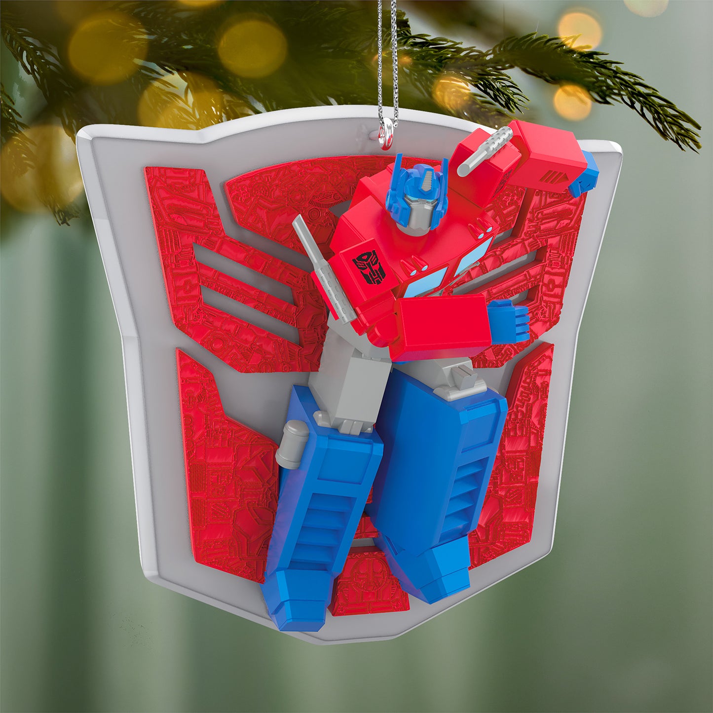 Hasbro Transformers Optimus Prime's Power — 2026 Hallmark Keepsake Christmas Ornament featuring Optimus Prime in action pose against a vibrant shield backdrop.