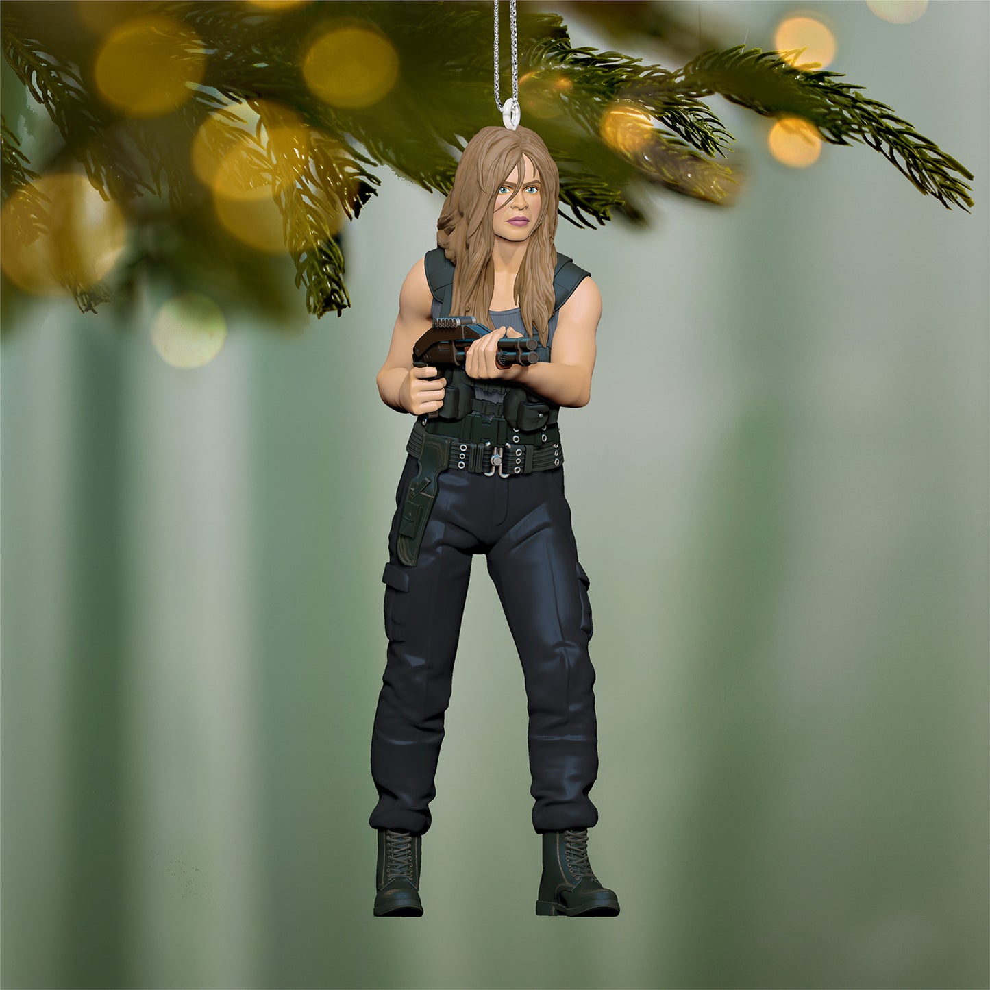 Terminator 2: Judgment Day™ Sarah Connor — 2026 Hallmark Keepsake Christmas Ornament in a detailed design, hanging from a tree branch with bokeh lights.