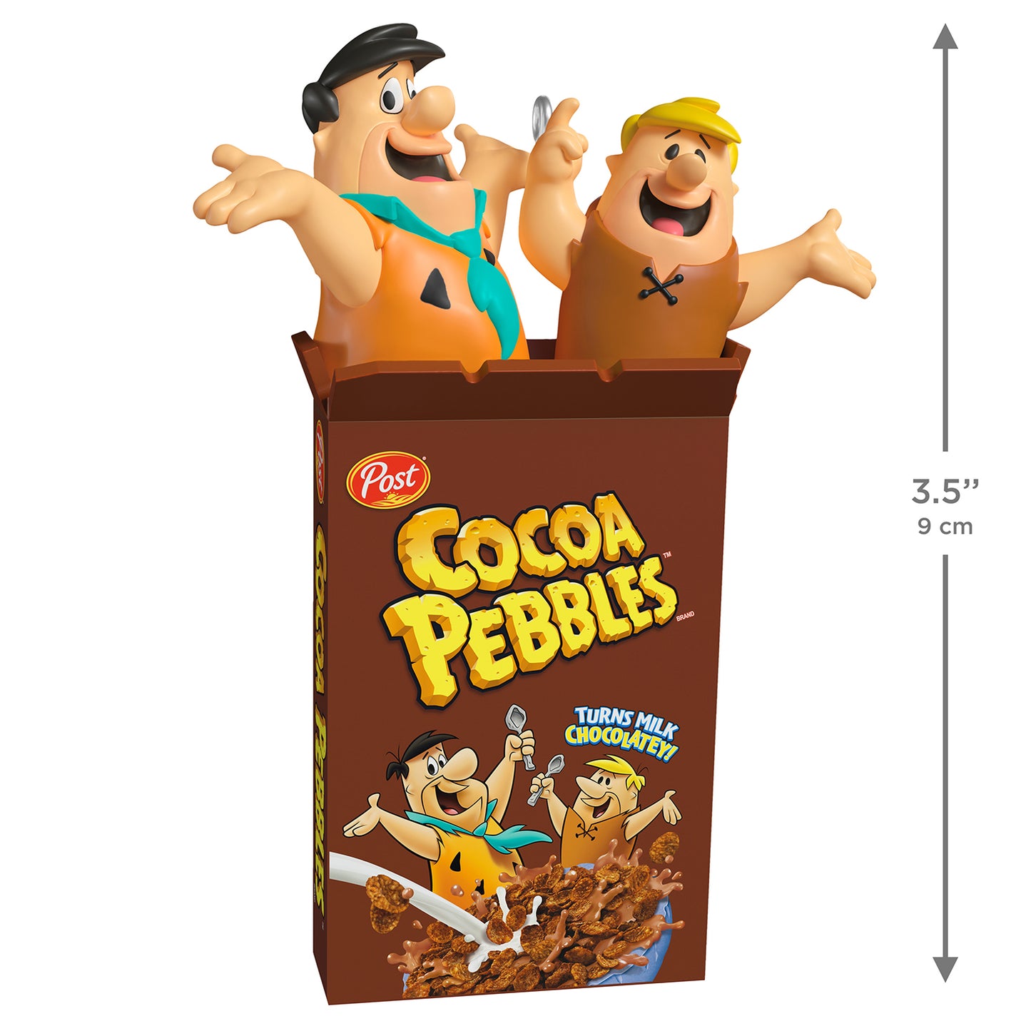 The Flintstones™ Cocoa Pebbles — 2026 Hallmark Keepsake Christmas Ornament, food-themed, cocoa brown cereal box, with Fred and Barney figurines, angled view.
