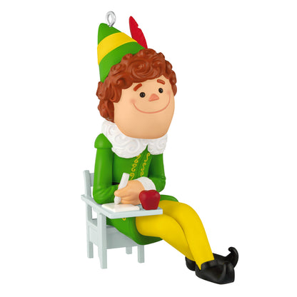 Elf Buddy the Elf — 2026 Hallmark Keepsake Christmas Ornament, seated at a school desk, holding an apple.