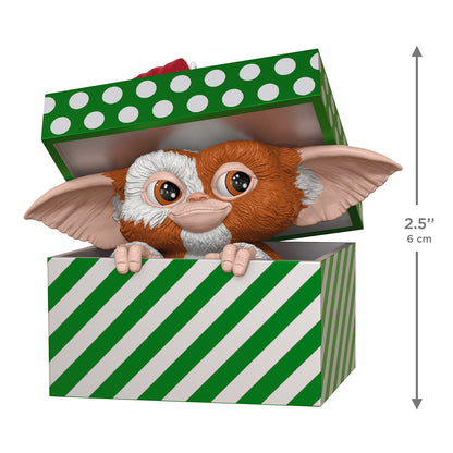 Gremlins Gizmo — 2026 Hallmark Keepsake Christmas Ornament, figurine peeking from a green gift box with polka dots, 6 cm tall.