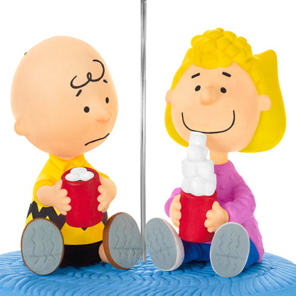 The Peanuts Gang More Marshmallows, Please! — 2026 Hallmark Keepsake Christmas Ornament featuring Charlie Brown and Sally holding mugs of cocoa with fluffy marshmallows.
