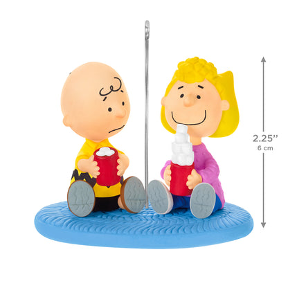 The Peanuts Gang More Marshmallows, Please! — 2026 Hallmark Keepsake Christmas Ornament with Charlie Brown and Sally holding mugs on a blue rug.