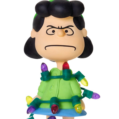 The Peanuts® Gang Lucy's All Tangled Up! — 2026 Hallmark Keepsake Christmas Ornament featuring Lucy entangled in colourful Christmas lights in a playful pose.