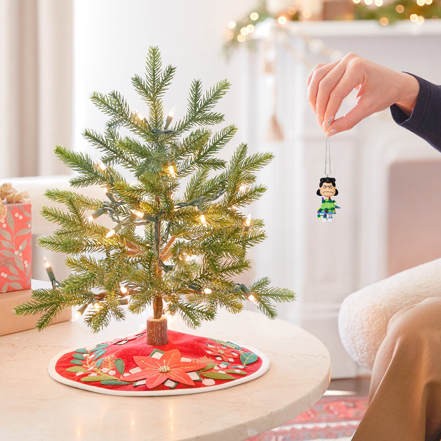 The Peanuts® Gang Lucy's All Tangled Up! — 2026 Hallmark Keepsake Christmas Ornament hanging from a small Christmas tree with lights.