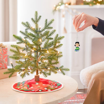 The Peanuts® Gang Lucy's All Tangled Up! — 2026 Hallmark Keepsake Christmas Ornament hanging from a small Christmas tree with lights.
