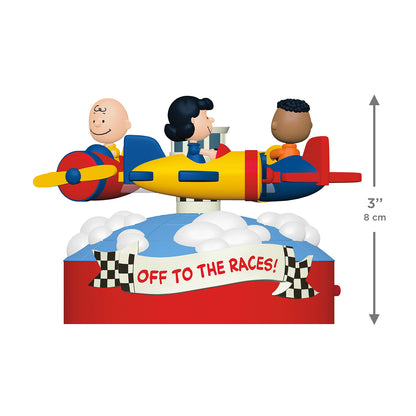 The Peanuts® Gang Off to the Races! Musical With Motion — 2026 Hallmark Keepsake Christmas Ornament featuring Charlie Brown, Lucy, and Franklin in colourful airplanes, 8 cm tall.